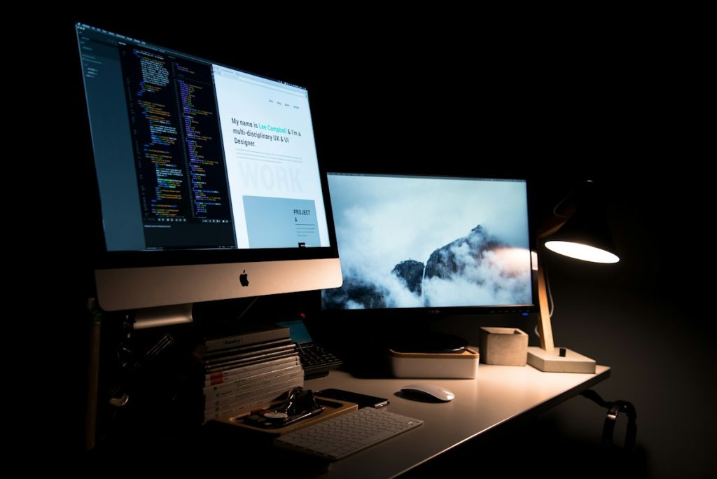 Designer workspace with laptop and sketches