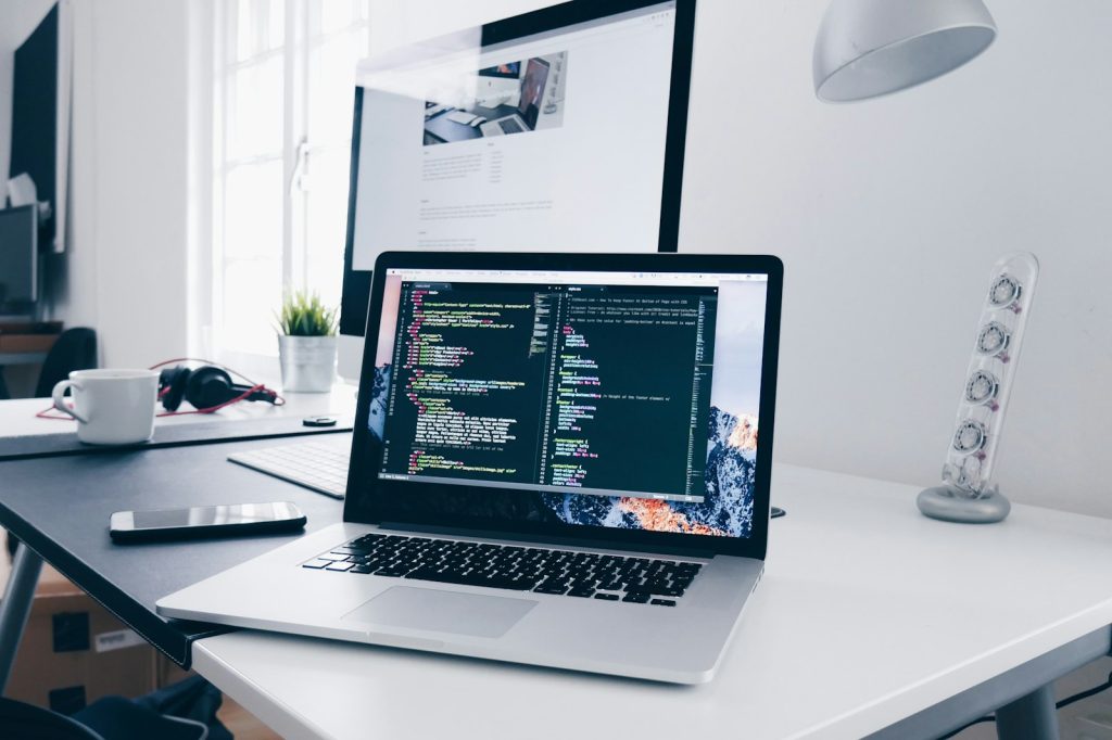 Laptop with code on screen on a developer desk