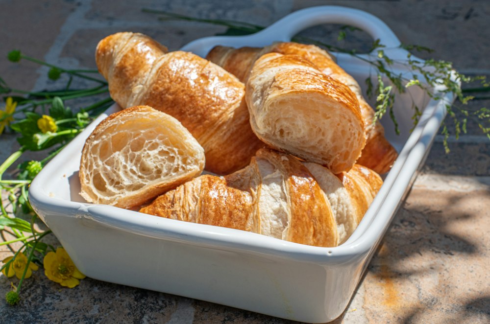 Croissants piled in a white bowl