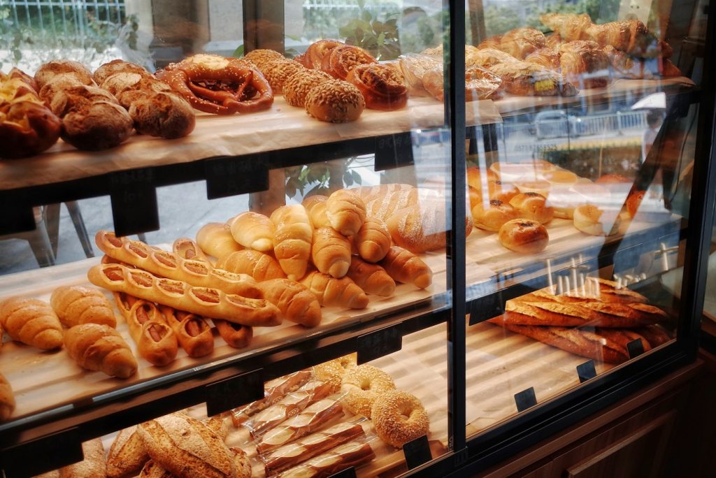 Fresh breads on a bakery display shelf