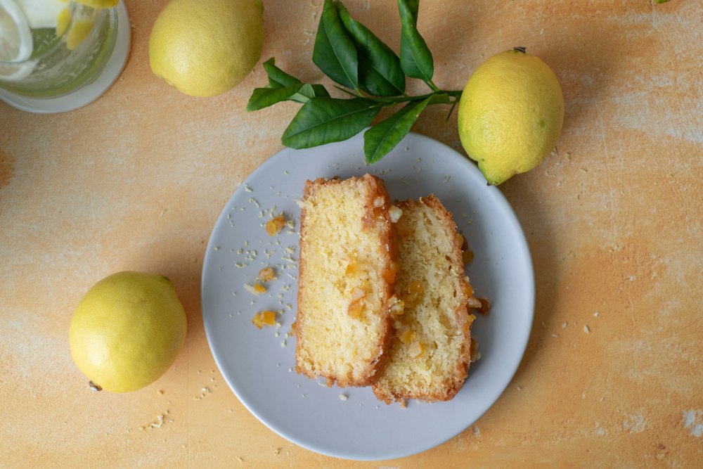 Sliced lemon loaf cake with whole lemons