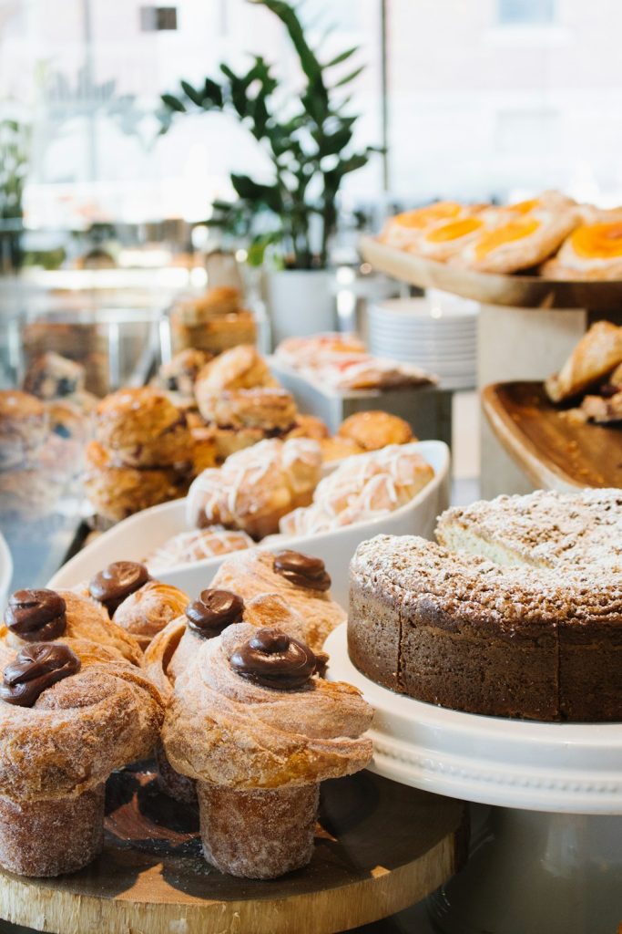 Chocolate-topped pastries and a crumb cake on display