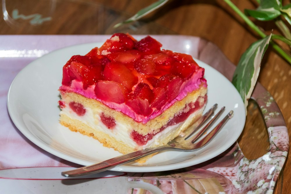 Slice of strawberry cake with cream and fresh fruit